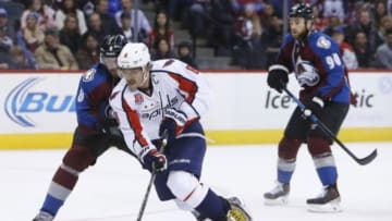 Nov 20, 2014; Denver, CO, USA; Washington Capitals left wing Alex Ovechkin (right) brings the puck up the ice against Colorado Avalanche defenseman Jan Hejda (left) during the third period at Pepsi Center. The Capitals won 3-2. Mandatory Credit: Chris Humphreys-USA TODAY Sports