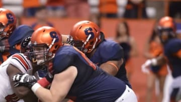 Oct 3, 2014; Syracuse, NY, USA; Syracuse Orange offensive tackle Sean Hickey (60) makes a block on a Louisville Cardinals defender during the second quarter of a game at the Carrier Dome. Louisville won the game 28-6. Mandatory Credit: Mark Konezny-USA TODAY Sports
