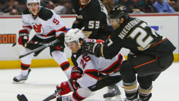 ANAHEIM, CA - JANUARY 11: Patrik Elias #26 of the New Jersey Devils is taken down by Scott Niedermayer #27 of the Anaheim Ducks on January 11, 2009 at the Honda Center in Anaheim, California. (Photo by Bruce Bennett/Getty Images)