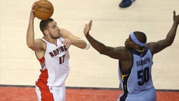 Mar 14, 2014; Toronto, Ontario, CAN; Toronto Raptors center Jonas Valanciunas (17) scores over Memphis Grizzlies forward Zach Randolph (50) at Air Canada Centre. The Raptors beat the Grizzlies 99-86. Mandatory Credit: Tom Szczerbowski-USA TODAY Sports