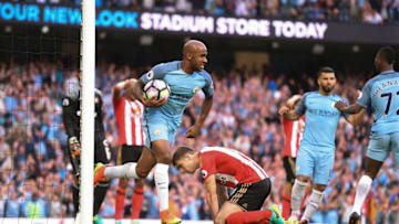 Manchester City's English midfielder Fabian Delph (CL) collects the ball after Sunderland's Northern Irish defender Paddy McNair (CR floor) scored an own goal during the English Premier League football match between Manchester City and Sunderland at the Etihad Stadium in Manchester, north west England, on August 13, 2016. / AFP / PAUL ELLIS / RESTRICTED TO EDITORIAL USE. No use with unauthorized audio, video, data, fixture lists, club/league logos or 'live' services. Online in-match use limited to 75 images, no video emulation. No use in betting, games or single club/league/player publications. / (Photo credit should read PAUL ELLIS/AFP/Getty Images)