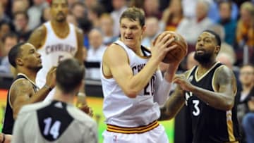 Jan 4, 2016; Cleveland, OH, USA; Cleveland Cavaliers center Timofey Mozgov (20) grabs a rebound ahead of Toronto Raptors forward James Johnson (3) during the fourth quarter at Quicken Loans Arena. Mandatory Credit: Ken Blaze-USA TODAY Sports