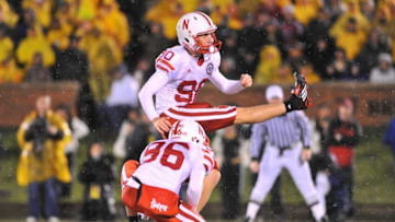 Oct 8, 2009; Columbia, MO, USA; Nebraska Cornhuskers placekicker Alex Henery (90) makes the extra point with punter Brett Maher (96) holding in the fourth quarter against the Missouri Tigers at Memorial Stadium. Nebraska won 27-12. Mandatory Credit: Denny Medley-USA TODAY Sports