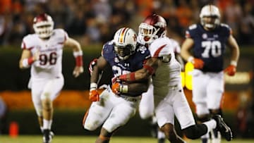 Oct 22, 2016; Auburn, AL, USA; Arkansas Razorbacks defensive back Santos Ramirez (9) tackles Auburn Tigers running back Kamryn Pettway (36) during the third quarter at Jordan Hare Stadium. The Tigers beat the Razorbacks 56-3. Mandatory Credit: John Reed-USA TODAY Sports