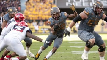 Nov 21, 2015; Tempe, AZ, USA; Arizona State Sun Devils wide receiver Tim White (12) runs the ball under pressure from Arizona Wildcats linebacker Sir Thomas Jackson (53) during the fourth quarter of the territorial cup at Sun Devil Stadium. The Sun Devils won 52-37. Mandatory Credit: Casey Sapio-USA TODAY Sports
