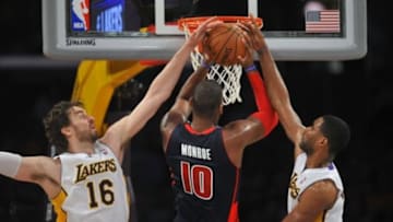 November 17, 2013; Los Angeles, CA, USA; Detroit Pistons power forward Greg Monroe (10) goes in for a basket against the defense of Los Angeles Lakers center Pau Gasol (16) and power forward Shawne Williams (3) during the second half at Staples Center. Mandatory Credit: Gary A. Vasquez-USA TODAY Sports
