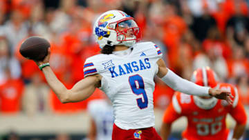 STILLWATER, OK - OCTOBER 14: Jason Bean #9 of the Kansas Jayhawks launches an incomplete pass late in the game against the Oklahoma State Cowboys at Boone Pickens Stadium on October 14, 2023 in Stillwater, Oklahoma. Oklahoma State won 39-32. (Photo by Brian Bahr/Getty Images)