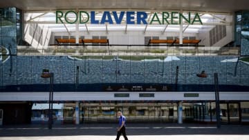 A man walks past the main entrance to Rod Laver Arena, home of the Australia Open in Melbourne, which is set to begin on January 17th. (Photo by WILLIAM WEST/AFP via Getty Images)