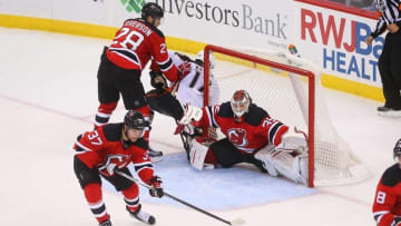 Oct 18, 2016; Newark, NJ, USA; New Jersey Devils center Pavel Zacha (37) clears the puck away from New Jersey Devils goalie Cory Schneider (35) during the third period at Prudential Center. The Devils defeated the Ducks 2-1. Mandatory Credit: Ed Mulholland-USA TODAY Sports
