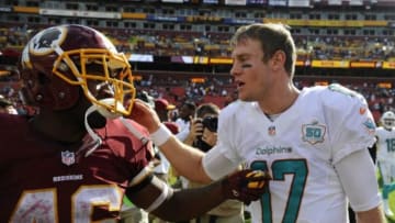 Sep 13, 2015; Landover, MD, USA; Miami Dolphins quarterback Ryan Tannehill (17) talks with Washington Redskins running back Alfred Morris (46) after the game at FedEx Field. Mandatory Credit: Brad Mills-USA TODAY Sports