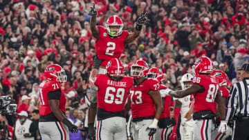 Nov 11, 2023; Athens, Georgia, USA; Georgia Bulldogs running back Kendall Milton (2) reacts with offensive lineman Tate Ratledge (69) after scoring a touchdown against the Mississippi Rebels during the first half at Sanford Stadium. Mandatory Credit: Dale Zanine-USA TODAY Sports