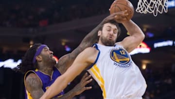 March 16, 2015; Oakland, CA, USA; Golden State Warriors center Andrew Bogut (12) grabs a rebound against Los Angeles Lakers center Jordan Hill (27) during the second quarter at Oracle Arena. Mandatory Credit: Kyle Terada-USA TODAY Sports