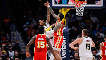 Nov 12, 2021; Denver, Colorado, USA; Atlanta Hawks forward John Collins (20) blocks the shot of Denver Nuggets guard Monte Morris (11) as center Clint Capela (15) and center Nikola Jokic (15) defend in the fourth quarter at Ball Arena. Mandatory Credit: Isaiah J. Downing-USA TODAY Sports