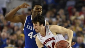 Apr 5, 2014; Arlington, TX, USA; Wisconsin Badgers forward Frank Kaminsky (right) drives against Kentucky Wildcats center Dakari Johnson in the second half during the semifinals of the Final Four in the 2014 NCAA Mens Division I Championship tournament at AT&T Stadium. Mandatory Credit: Robert Deutsch-USA TODAY Sports