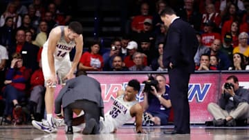 TUCSON, AZ - DECEMBER 18: Trainer Justin Kokoskie examines Allonzo Trier