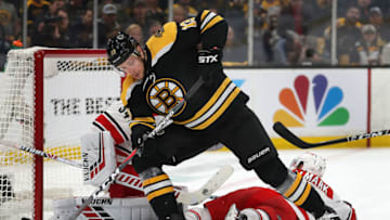 BOSTON - MAY 12: Boston Bruins' Charlie Coyle can't get control of the puck in the second period in front of Carolina goalie Petr Mrazek (34, left) and Lucas Wallmark (71, on ice at right). The Boston Bruins host the Carolina Hurricanes in Game 2 of the NHL Eastern Conference Finals on May 12, 2019. (Photo by John Tlumacki/The Boston Globe via Getty Images)