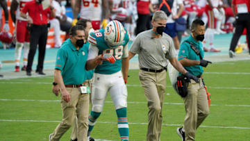 MIAMI GARDENS, FLORIDA - DECEMBER 13: Mike Gesicki #88 of the Miami Dolphins is escorted off the field against the Kansas City Chiefs during the second half in the game at Hard Rock Stadium on December 13, 2020 in Miami Gardens, Florida. (Photo by Mark Brown/Getty Images)