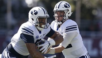 STARKVILLE, MS - OCTOBER 14: Tanner Mangum #12 of the Brigham Young Cougars hands the ball to Ula Tolutau #5 during the first half of a game against the Mississippi State Bulldogs at Davis Wade Stadium on October 14, 2017 in Starkville, Mississippi. (Photo by Jonathan Bachman/Getty Images)