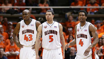 CHAMPAIGN, IL - FEBRUARY 12: Roger Powell Jr. #43, Deron Williams #5 and Luther Head #4 of the Illinois Fighting Illini look on during a game against the Wisconsin Badgers at Assembly Hall on February 12, 2005 in Champaign, Illinois. Illinois defeated Wisconsin 70-59 during their run to the Final Four. (Photo by Joe Robbins/Getty Images)