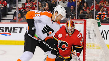 CALGARY, AB - OCTOBER 15: David Rittich #33 of the Calgary Flames stops a shot from James Van Riemsdyk #25 of the Philadelphia Flyers during an NHL game at Scotiabank Saddledome on October 15, 2019 in Calgary, Alberta, Canada. (Photo by Derek Leung/Getty Images)