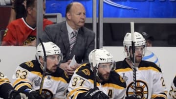 Jun 22, 2013; Chicago, IL, USA; Boston Bruins center Patrice Bergeron (37) sits on the bench in front of head coach Claude Julien during the first period in game five of the 2013 Stanley Cup Final against the Chicago Blackhawks at the United Center. Mandatory Credit: Rob Grabowski-USA TODAY Sports