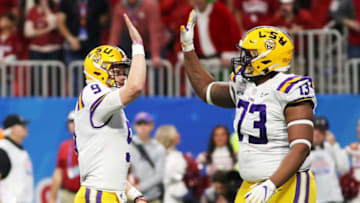 ATLANTA, GEORGIA - DECEMBER 28: Quarterback Joe Burrow #9 and offensive lineman Adrian Magee #73 of the LSU Tigers celebrate a touchdown in the first quarter of the game against the Oklahoma Sooners during the Chick-fil-A Peach Bowl at Mercedes-Benz Stadium on December 28, 2019 in Atlanta, Georgia. (Photo by Gregory Shamus/Getty Images)