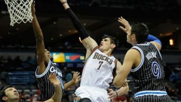 Mar 10, 2014; Milwaukee, WI, USA; Milwaukee Bucks forward Ersan Ilyasova (7) takes a shot against Orlando Magic center Nikola Vucevic (9) in the third quarter at BMO Harris Bradley Center. Mandatory Credit: Benny Sieu-USA TODAY Sports