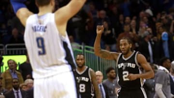 Feb 10, 2016; Orlando, FL, USA; San Antonio Spurs forward Kawhi Leonard (2) pumps his fist hitting the game winning basket as Orlando Magic center Nikola Vucevic (9) looks on at Amway Center. San Antonio defeated Orlando 98-96. Mandatory Credit: Kim Klement-USA TODAY Sports