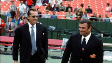 KANSAS CITY, MO - CIRCA 1973: Head Coach Hank Stram (R) of the Kansas City Chiefs and Al Davis owner of the Oakland Raiders looks on prior to the start of an NFL football game circa 1973 at Arrowhead Stadium in Kansas City, Missouri. Stram was coach of the Dallas Texans/Kansas City Chiefs from 1960-1974. (Photo by Focus on Sport/Getty Images)