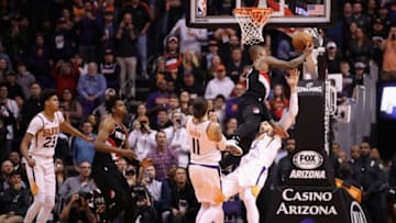 PHOENIX, ARIZONA - DECEMBER 16: Damian Lillard #0 of the Portland Trail Blazers drives to the basket against Aron Baynes #46 of the Phoenix Suns during the final moments of the second half of the NBA game at Talking Stick Resort Arena on December 16, 2019 in Phoenix, Arizona. The Trail Blazers defeated the Suns 111-110. NOTE TO USER: User expressly acknowledges and agrees that, by downloading and/or using this photograph, user is consenting to the terms and conditions of the Getty Images License Agreement. (Photo by Christian Petersen/Getty Images)
