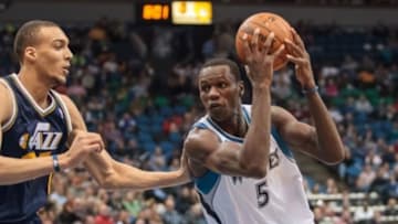 Apr 16, 2014; Minneapolis, MN, USA; Minnesota Timberwolves center Gorgui Dieng (5) drives in the second quarter against the Utah Jazz center Rudy Gobert (27) at Target Center. Mandatory Credit: Brad Rempel-USA TODAY Sports