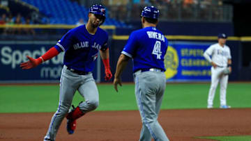 Lourdes Gurriel Jr. #13 of the Toronto Blue Jays is congratulated after hitting a two run home run in the first inning during a game against the Tampa Bay Rays at Tropicana Field. (Photo by Mike Ehrmann/Getty Images)