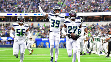 Dec 4, 2022; Inglewood, California, USA; Seattle Seahawks cornerback Tariq Woolen (27) celebrates after intercepting a pass intended for Los Angeles Rams running back Kyren Williams (23) during the first half at SoFi Stadium. Mandatory Credit: Gary A. Vasquez-USA TODAY Sports