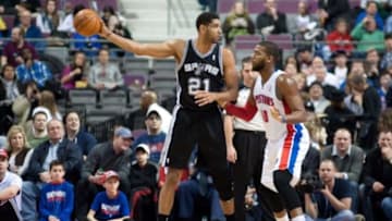 Feb 10, 2014; Auburn Hills, MI, USA; Detroit Pistons power forward Greg Monroe (10) guards San Antonio Spurs power forward Tim Duncan (21) during the first quarter at The Palace of Auburn Hills. Mandatory Credit: Tim Fuller-USA TODAY Sports