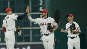 HOUSTON, TX - JULY 02: Carlos Correa #1 of the Houston Astros high fives Jake Marisnick #6 and Norichika Aoki #3 after the final out against the New York Yankees at Minute Maid Park on July 2, 2017 in Houston, Texas. (Photo by Bob Levey/Getty Images)