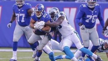 Dec 20, 2015; East Rutherford, NJ, USA; Carolina Panthers middle linebacker A.J. Klein (56) wraps up New York Giants running back Rashad Jennings (23) during the second quarter at MetLife Stadium. Mandatory Credit: Jim O
