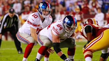 December 3, 2012; Landover, MD, USA; New York Giants quarterback Eli Manning (10) prepares to take a snap from Giants center David Baas (64) against the Washington Redskins at FedEx Field. Mandatory Credit: Geoff Burke-USA TODAY Sports