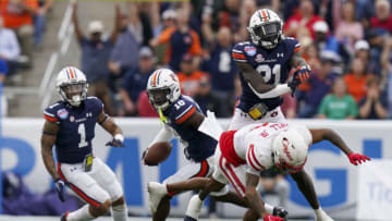 Auburn footballDec 28, 2021; Birmingham, Alabama, USA; Auburn Tigers safety Smoke Monday (21) blocks Houston Cougars wide receiver Nathaniel Dell (1) after Auburn Tigers cornerback Nehemiah Pritchett (18) intercepts the ball during the second half of the 2021 Birmingham Bowl at Protective Stadium. Mandatory Credit: Marvin Gentry-USA TODAY Sports