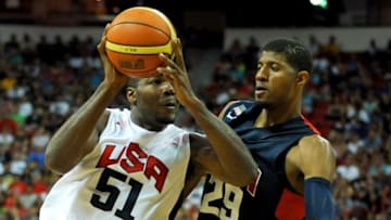 Aug 1, 2014; Las Vegas, NV, USA; USA Team White forward Paul Milsap (51) drives the ball against the defense of USA Team Blue guard Paul George (29) during the USA Basketball Showcase at Thomas & Mack Center. Mandatory Credit: Stephen R. Sylvanie-USA TODAY Sports