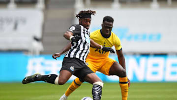 NEWCASTLE UPON TYNE, ENGLAND - APRIL 04: Allan Saint-Maximin of Newcastle United and Davinson Sanchez of Tottenham Hotspur during the Premier League match between Newcastle United and Tottenham Hotspur at St. James Park on April 4, 2021 in Newcastle upon Tyne, United Kingdom. Sporting stadiums around the UK remain under strict restrictions due to the Coronavirus Pandemic as Government social distancing laws prohibit fans inside venues resulting in games being played behind closed doors. (Photo by Robbie Jay Barratt - AMA/Getty Images)