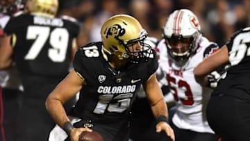 Nov 26, 2016; Boulder, CO, USA; Colorado Buffaloes quarterback Sefo Liufau (13) scrambles with the ball in the first half against the Utah Utes at Folsom Field. Mandatory Credit: Ron Chenoy-USA TODAY Sports