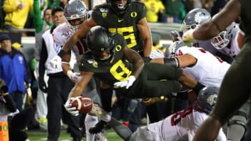 EUGENE, OREGON - OCTOBER 26: Jevon Holland #8 of the Oregon Ducks dives for a 19 yard pick six against the Washington State Cougars in the second quarter during their game at Autzen Stadium on October 26, 2019 in Eugene, Oregon. (Photo by Abbie Parr/Getty Images)