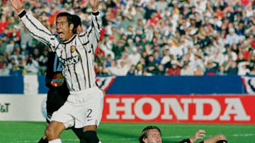 FOXBORO, UNITED STATES: #20 John Maessner (on the ground) of the D.C. United watches as #2 Danny Pena (L) of the Los Angeles Galaxy screams at the sideline referee who disallowed his goal during the first half of the Major League Soccer Championship game at Foxboro Stadium in Foxboro, Massachusetts 21 November, 1999 AFP PHOTO/ John MOTTERN (Photo credit should read JOHN MOTTERN/AFP via Getty Images)