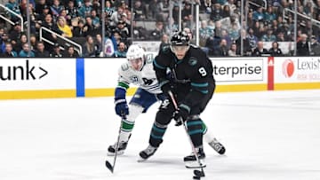 SAN JOSE, CA - DECEMBER 14: Evander Kane #9 of the San Jose Sharks skates ahead with the puck against Quinn Hughes #43 of the Vancouver Canucks at SAP Center on December 14, 2019 in San Jose, California. (Photo by Brandon Magnus/NHLI via Getty Images)