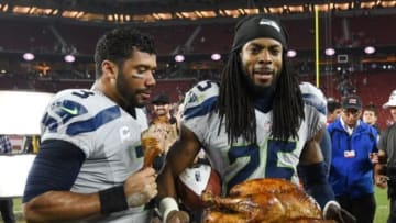 November 27, 2014; Santa Clara, CA, USA; Seattle Seahawks quarterback Russell Wilson (3, left) and cornerback Richard Sherman (25) carry the turkey to the locker room after the game against the San Francisco 49ers at Levi