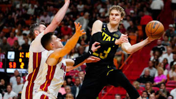 Mar 13, 2023; Miami, Florida, USA; Utah Jazz forward Lauri Markkanen (23) throws a pass as Miami Heat guard Tyler Herro (14) defends during the second quarter at Miami-Dade Arena. Mandatory Credit: Rich Storry-USA TODAY Sports