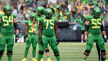 EUGENE, OR - SEPTEMBER 08: (L-R) Offensive linemen Calvin Throckmorton #54, Dallas Warmack #75, and Jake Hanson #55 of the Oregon Ducks offensive line, set up in front of Justin Herbert #10 of the Oregon Ducks during the first half of the game against the Portland State Vikings at Autzen Stadium on September 8, 2018 in Eugene, Oregon.