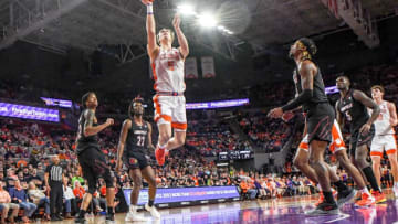Jan 11, 2023; Clemson, South Carolina, USA; Clemson Tigers forward Hunter Tyson (5) scores near Louisville Cardinals forward Kamari Lands (22) during the second half at Littlejohn Coliseum. Mandatory Credit: Ken Ruinard-USA TODAY Sports