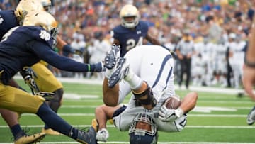 Sep 10, 2016; South Bend, IN, USA; Nevada Wolf Pack tight end Jarred Gipson (47) flips as he is tackled by Notre Dame Fighting Irish linebacker Te