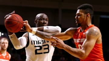 Jan 2, 2016; Coral Gables, FL, USA; Miami Hurricanes center Tonye Jekiri (23) battles for control of a rebound with Syracuse Orange forward Michael Gbinije (0) during the second half at BankUnited Center. Miami won 64-51. Mandatory Credit: Steve Mitchell-USA TODAY Sports